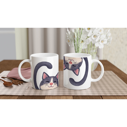 Två tecknade kattmuggar placerade på en duk, en med katten upp och en med katten ned – Tecknad mugg