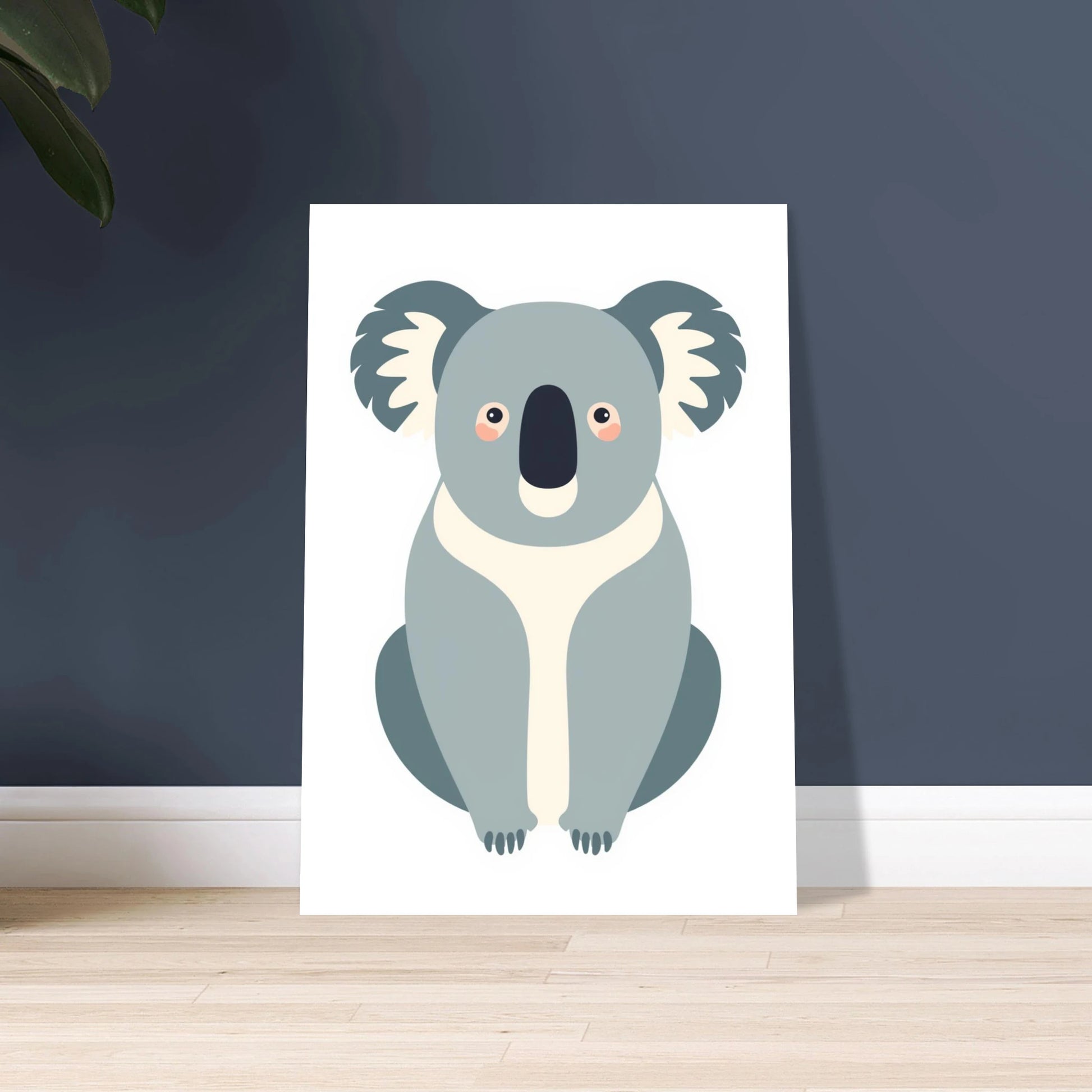 Inramad koalaposter lutad mot en mörkblå vägg i ett modernt hem